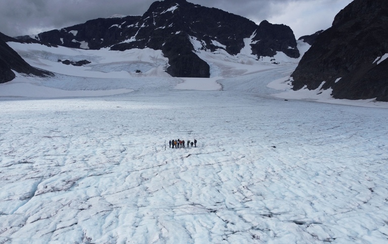 Drone photograph of the excursion team on Storglaciären, with Kebnekaise south peak visible in the b